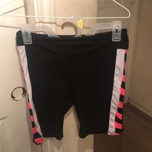 Black biker shorts with pink stripes.